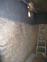 Insulated foundation wall using spray foam and intumescent paint as fire protection