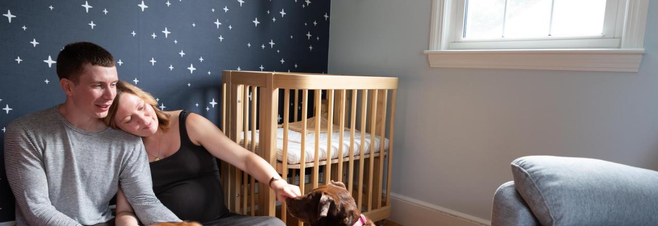 happy couple in comfortable bedroom with dogs on the floor