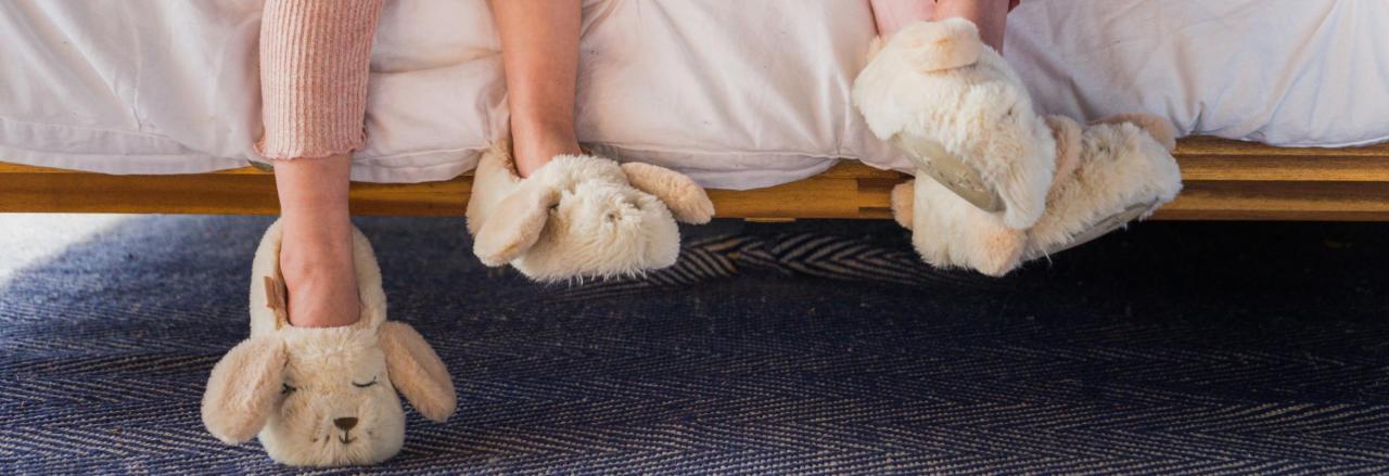 Girls Legs and Slippers with a Comfortable Bed