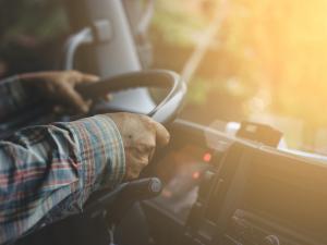 man in plaid driving a truck