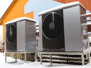 heat pump outside of home covered with snow