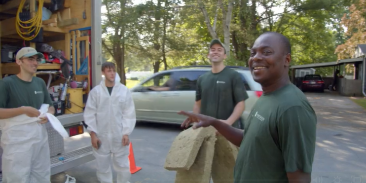 Evergreen Home Performance employees chatting and laughing together outside truck Evergreen Home Performance employees chatting and laughing together outside truck