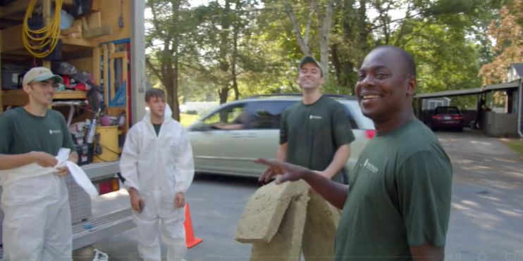 Evergreen Home Performance employees chatting and laughing together outside truck