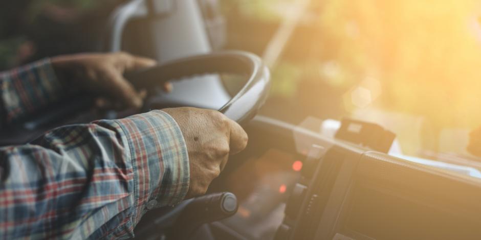 man in plaid driving a truck