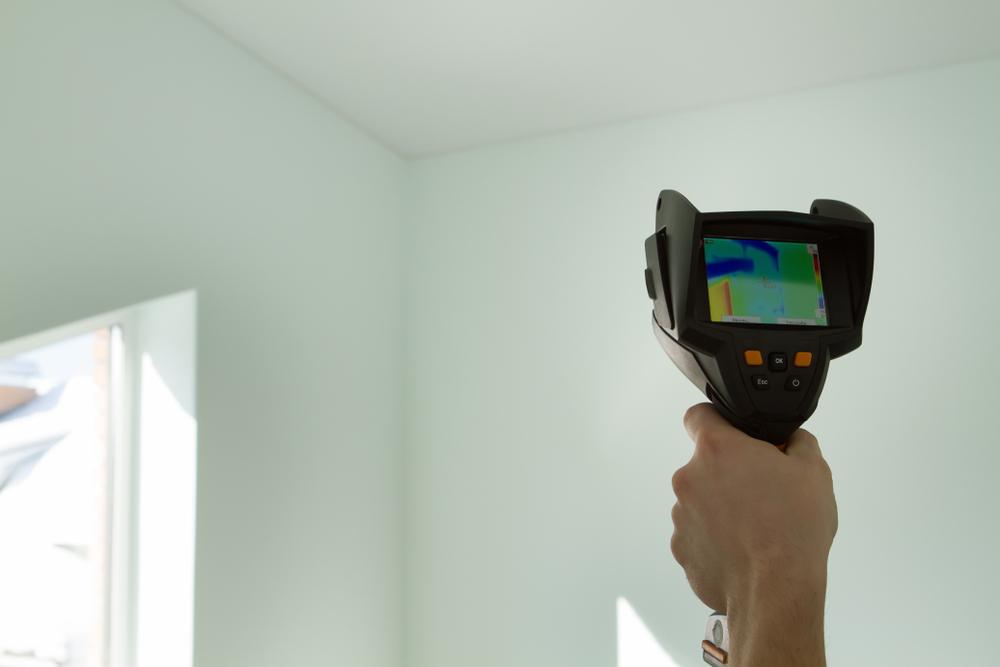 technician using thermal imaging inside home