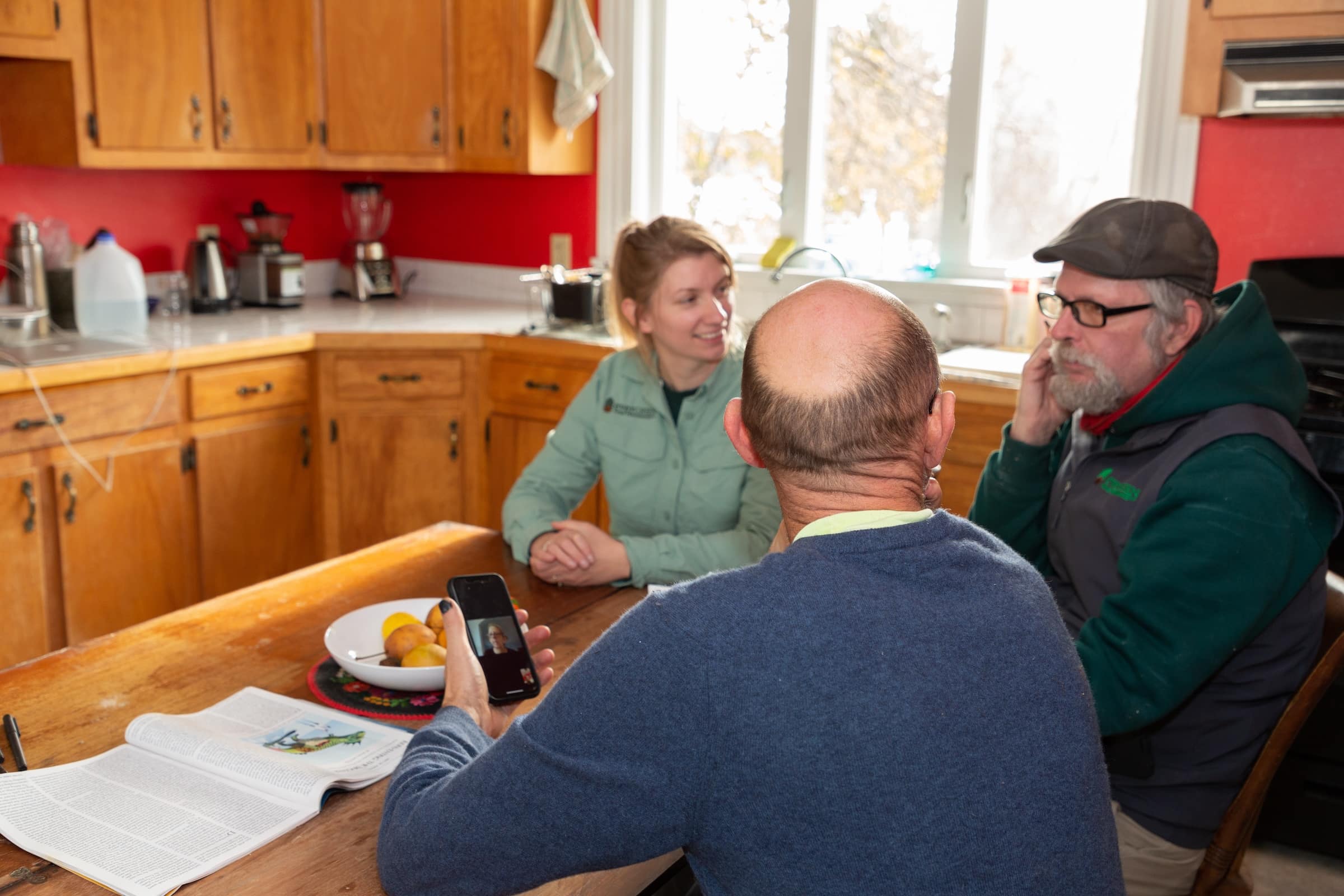 Evergreen team sitting around the table discussing plan with homeowner
