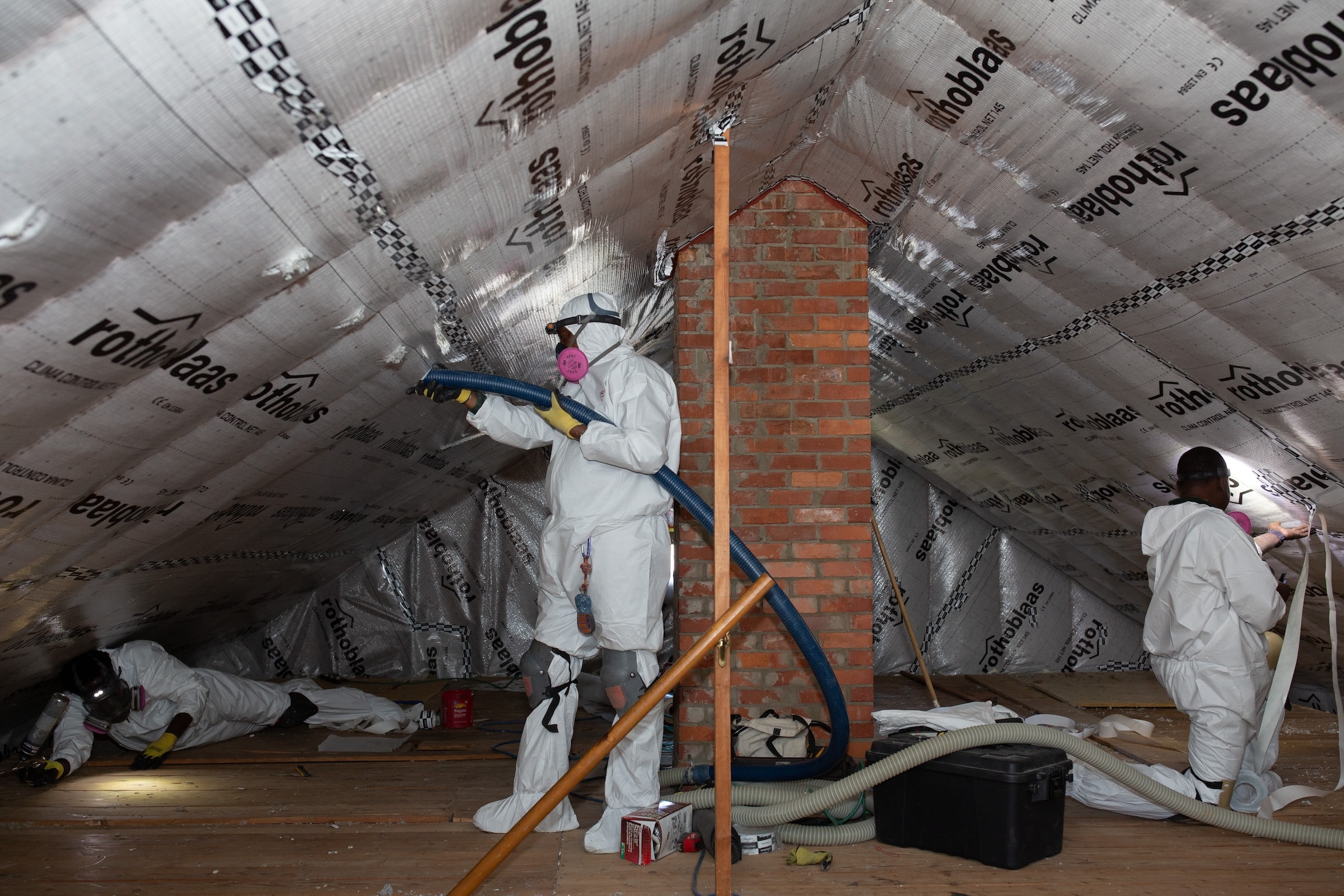 Evergreen Team Installing Insulation In Attic