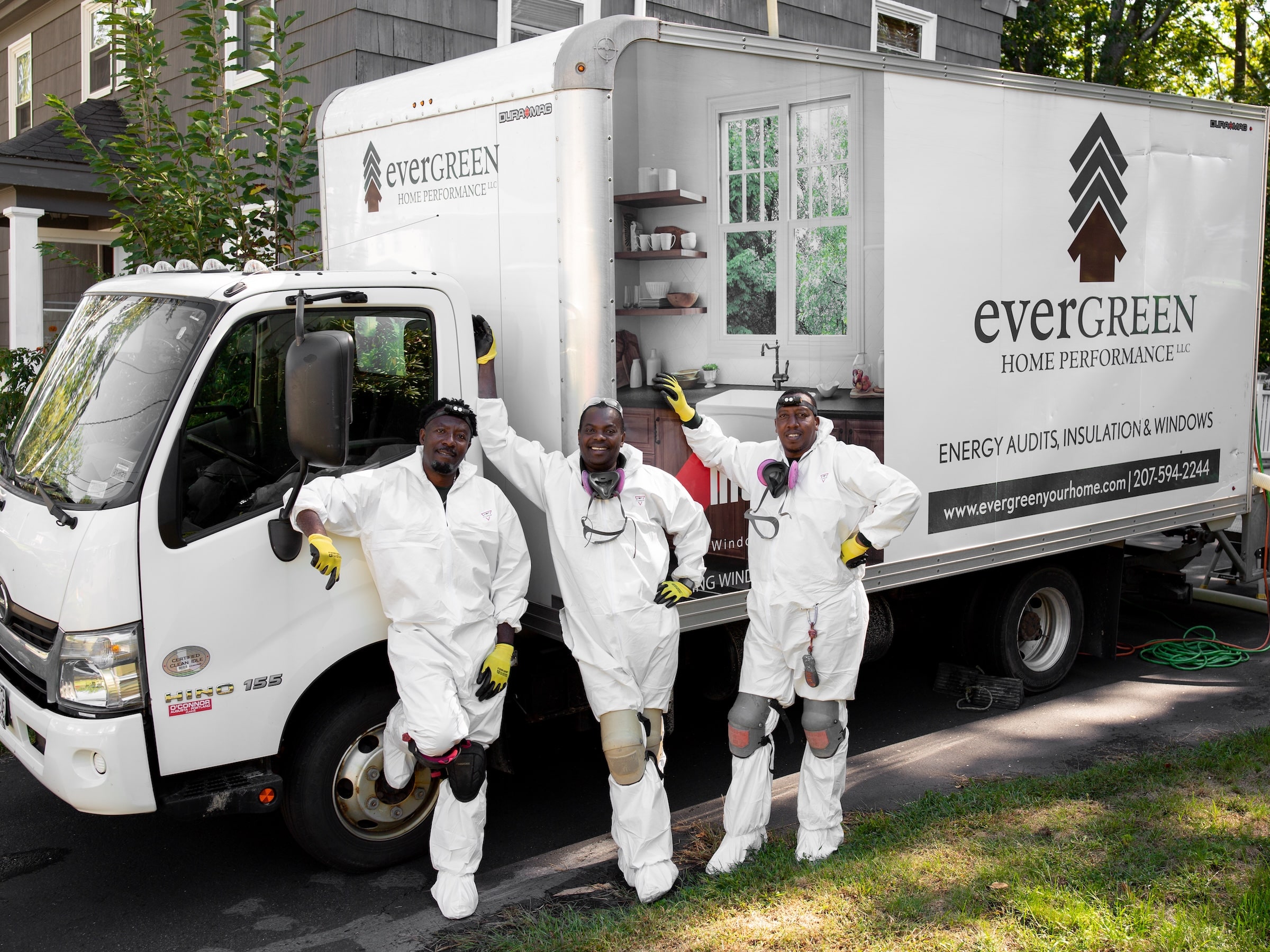Happy Evergreen Team Pictured In Front Of Box Truck