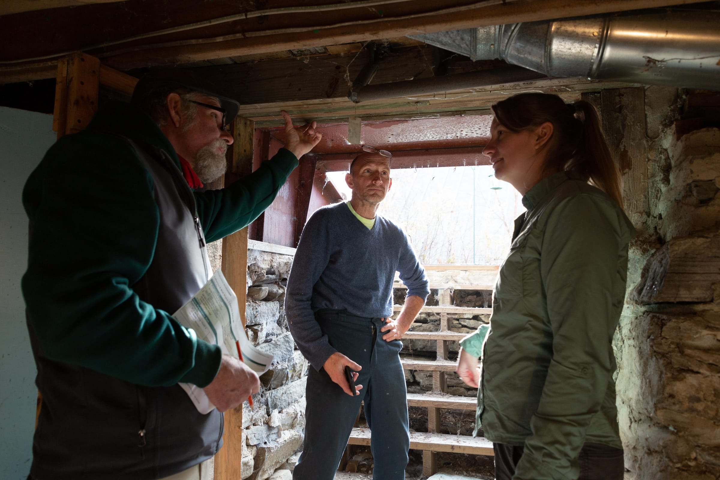 Evergreen team walking through basement