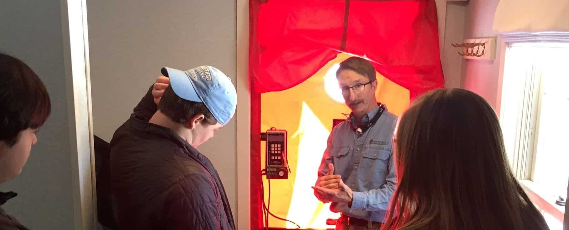 Evergreen Energy Advisor, Brian Robinson walking through a blower door test with a group of people in a house