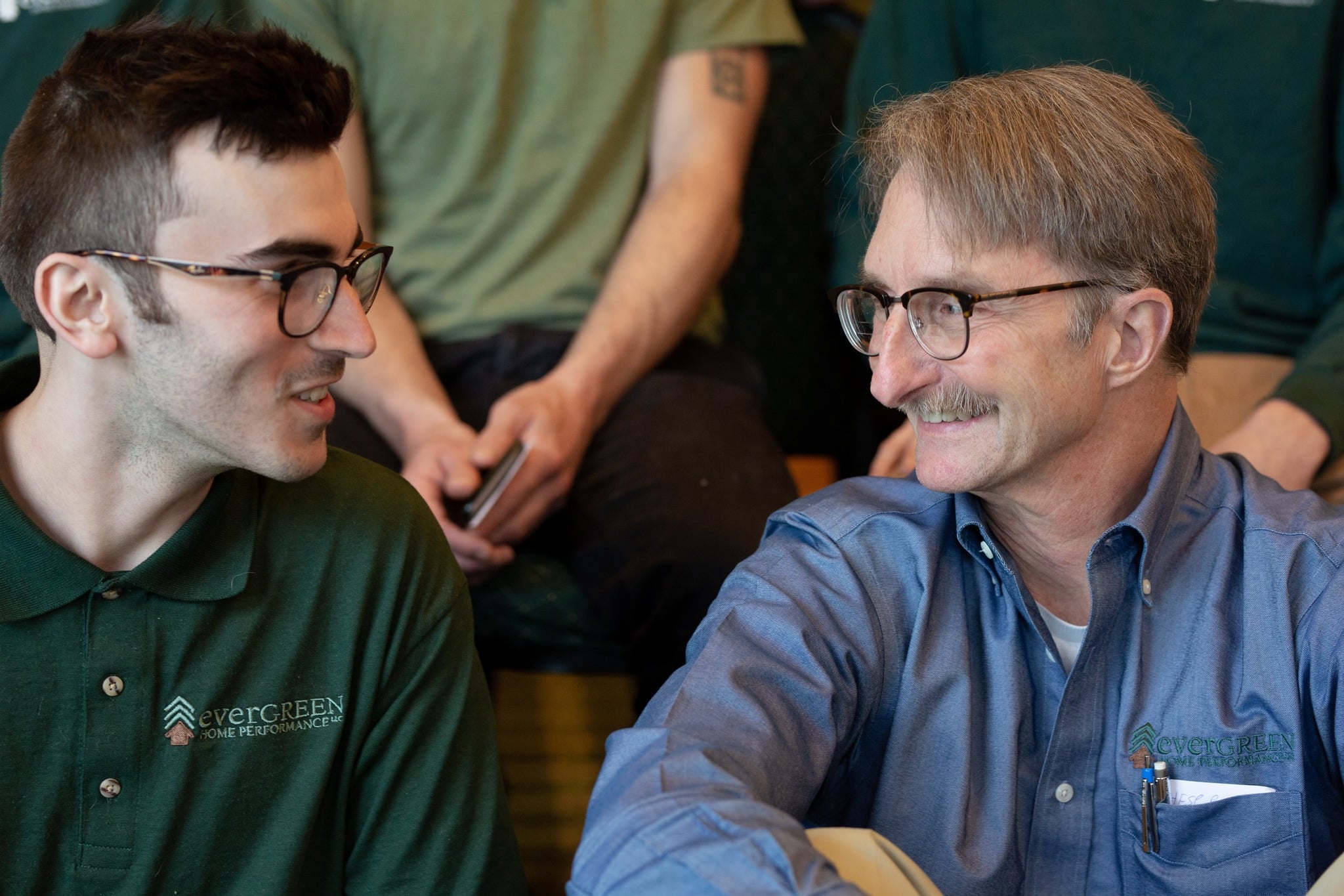 Evergreen team smiling at each other