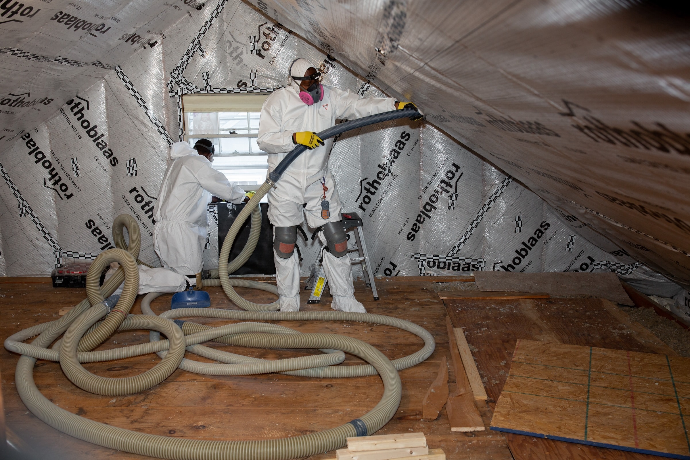 Evergreen team installing attic insulation