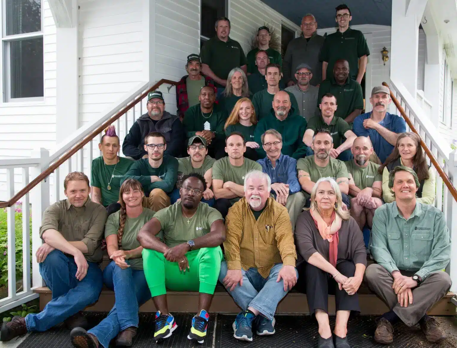 Evergreen Home Performance Team Photo On Porch Stairs Of Old Cape House