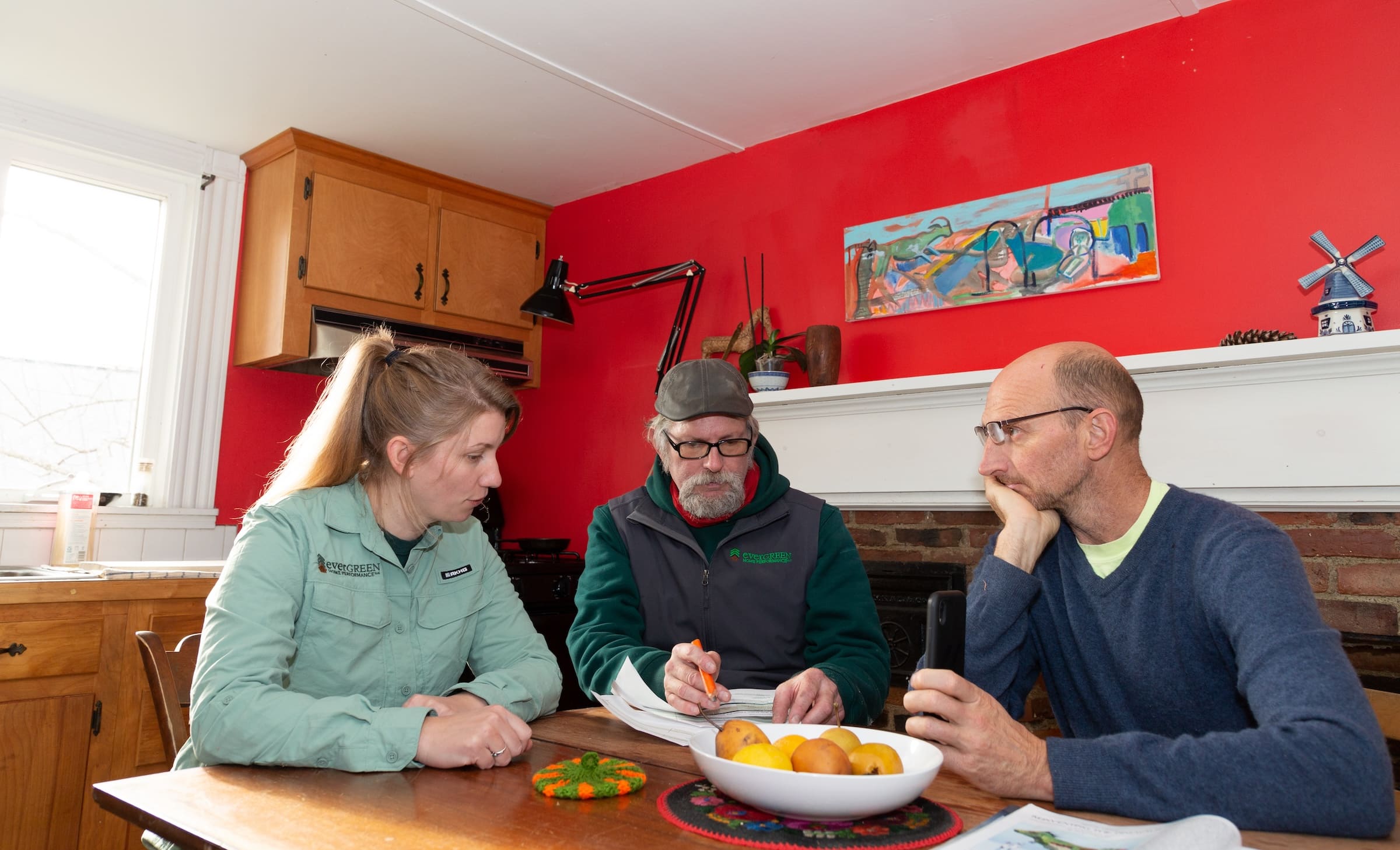 Evergreen team discussing plan with homeowner
