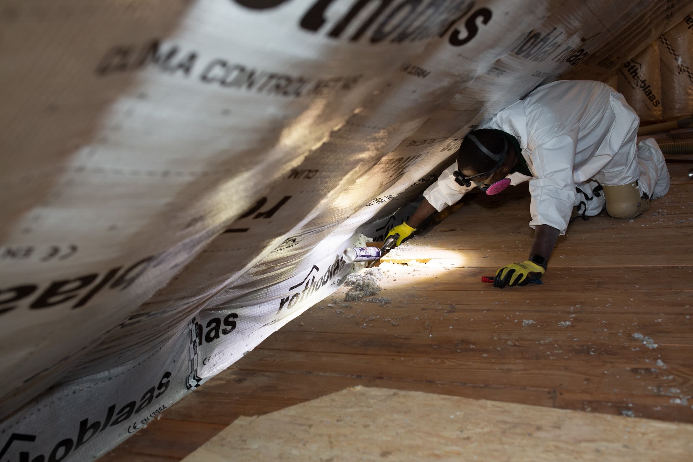 Evergreen team air sealing with caulk in attic