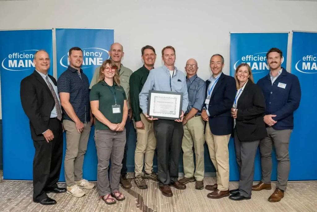 Evergreen Home Performance team members accepting award from Efficiency Maine
