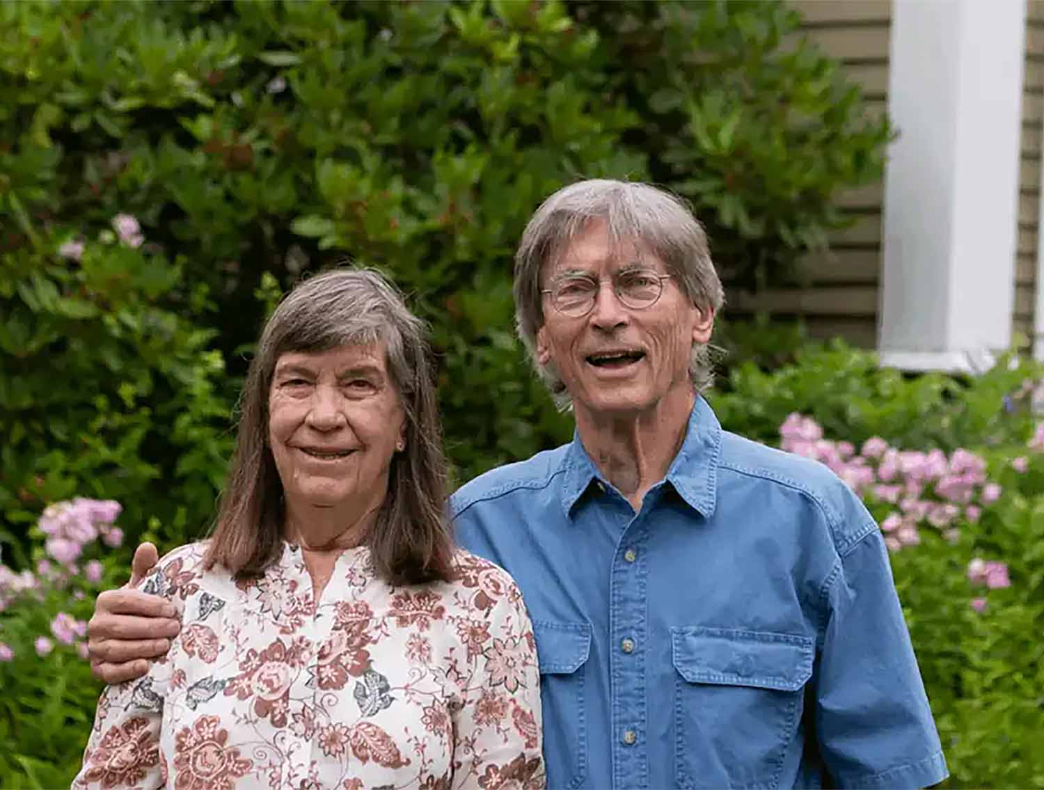 couple standing in front of house