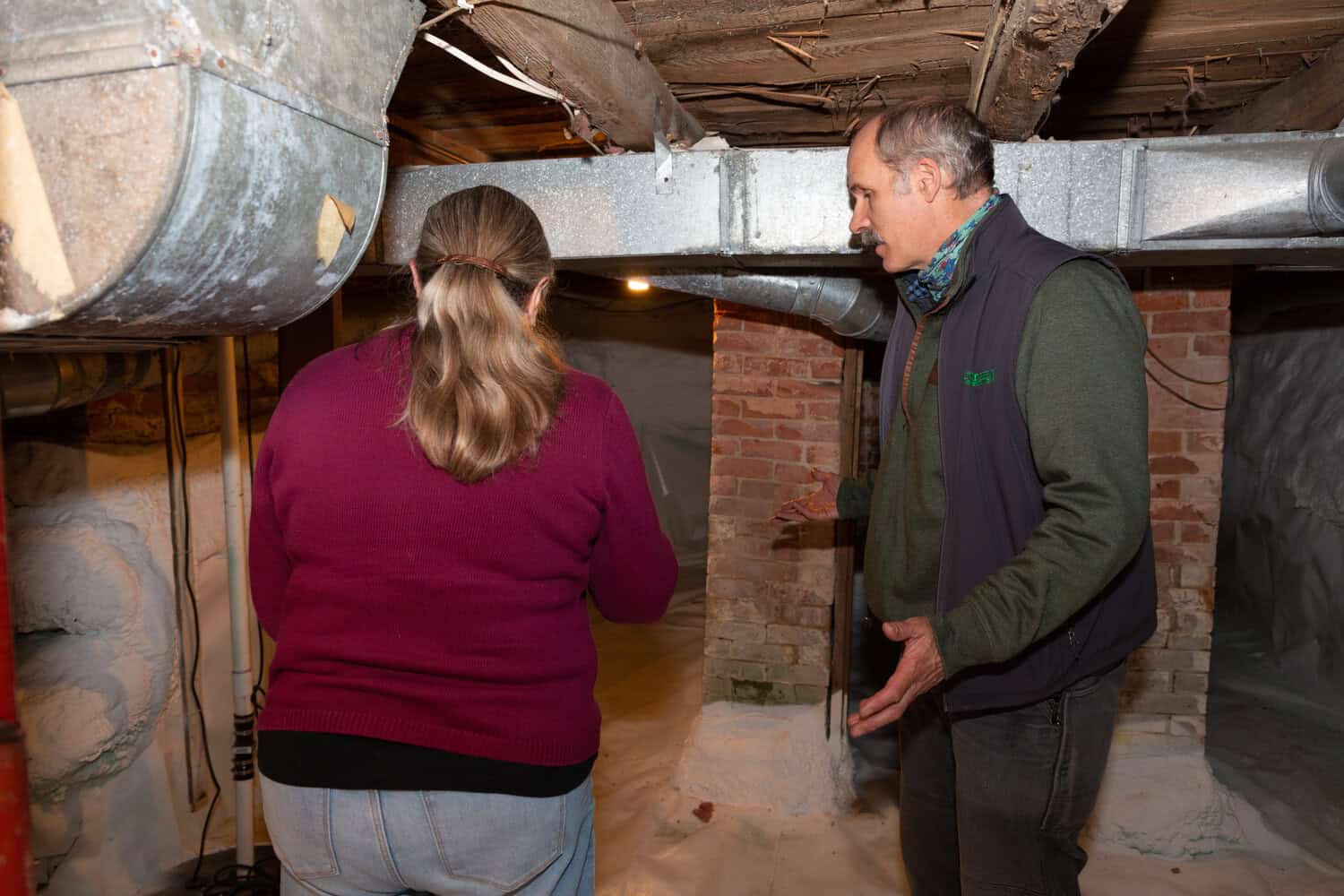 Evergreen team member evaluating basement with Maine homeowner